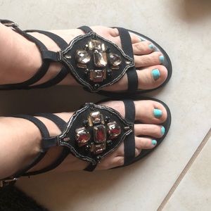 Flat embellished e collection sandals.